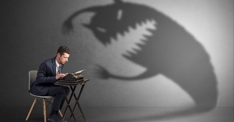 dipendente stressato al computer con ombra minacciosa