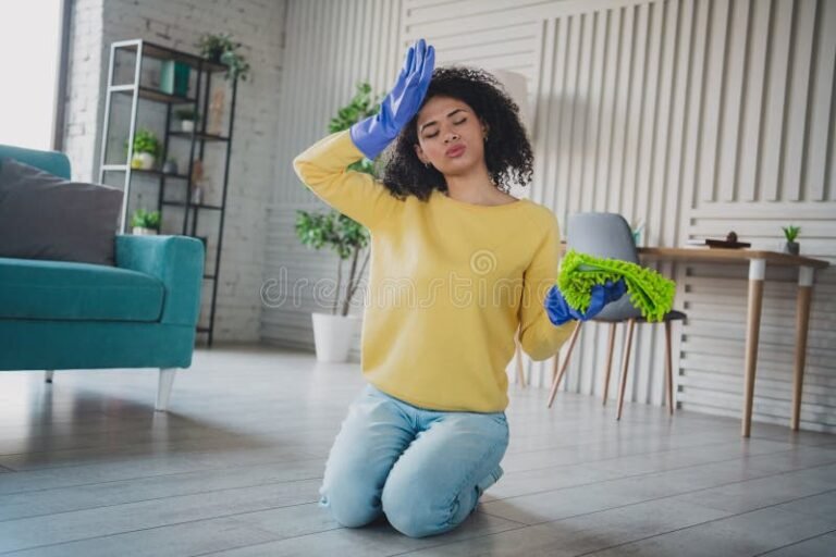 donna felice che pulisce casa luminosa