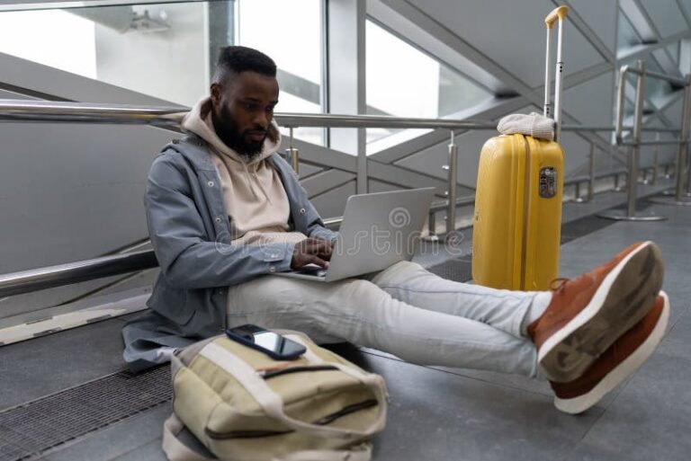 Come Posso Studiare e Lavorare All'Estero Contemporaneamente 28 studente con laptop e valigia in aeroporto